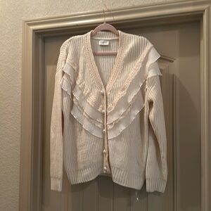 Cream cardigan sweater.
